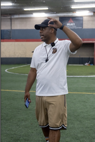 Victor Gardner coaching athletes on the field